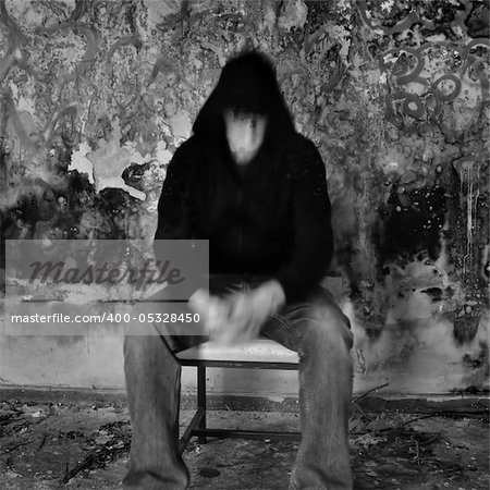 Man dissolving into textured black mold and peeling paint wall.