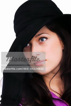 Portrait of a beautiful brunette young woman with black hat and gloves
