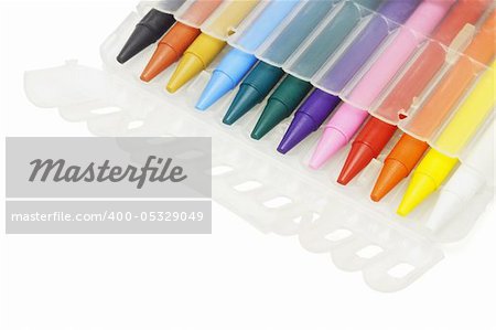 Multicolor crayons in plastic case on white background