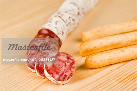 Spanish fuet salami chopped on  wooden board