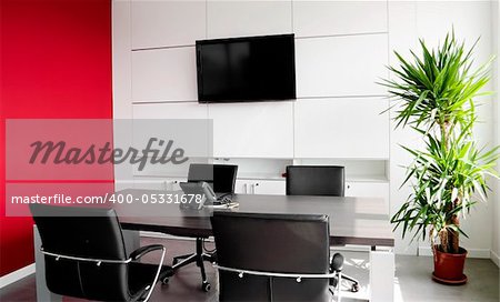 Interior office building with furniture and a red wall