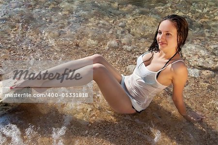 beautiful young  brunette woman on the sea beach