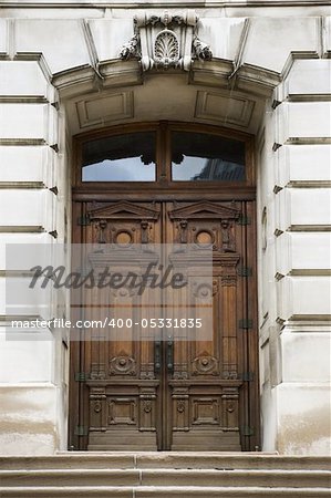 Old ornate wooden doors in a stone entry