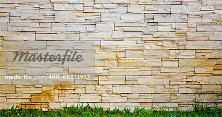 Stone wall with grass under lining
