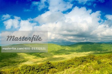 Green hill with blue sky. Summer landscape