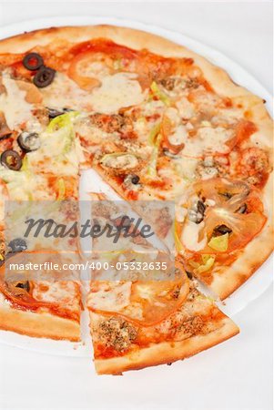 seafood pizza closeup with salmon, shrimps, tomato, pepper, olive and mozzarella cheese on a white background