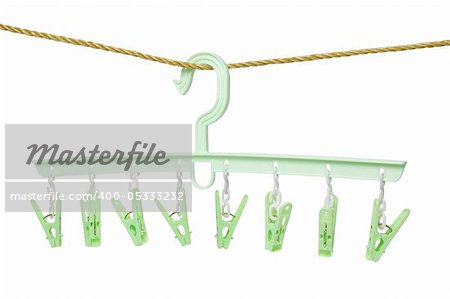 Plastic clothes hanger with hanging pegs on white background