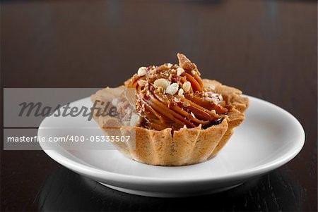 fresh baked cupcake with nuts on a wooden table