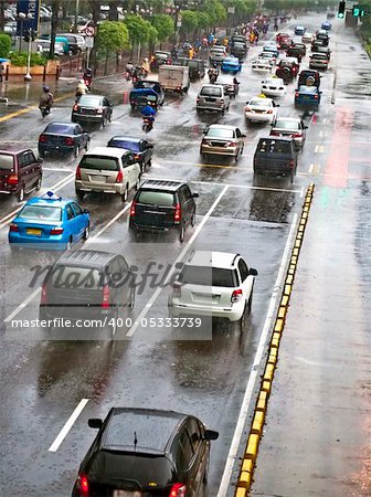 Crowded traffic jam in urban street in bad weather