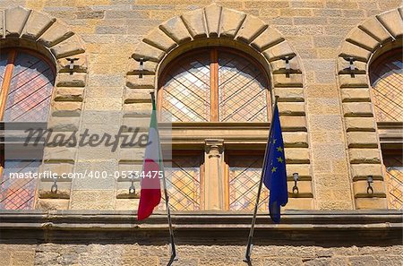 Italian And EU Flags on the Facade of a Historic Building