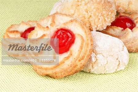 Close-up of assorted sicilian almond pastries decorated with candies cherries, icing sugar and granulated sugar. Selective focus.
