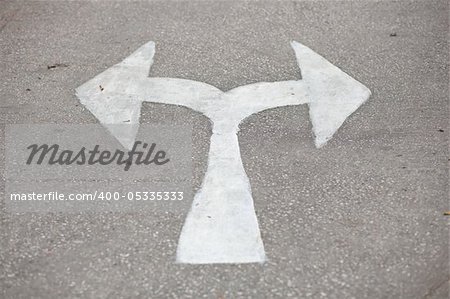 white arrow on the road. head arrow turn left and turn right.