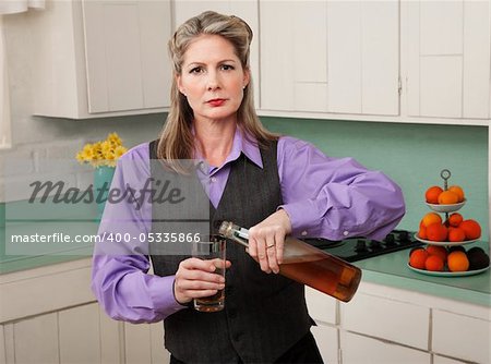 Woman in drag pouring alcohol into a glass