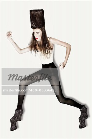 attractive young fashion model with sculpted hair and galaxy high-heels shot in studio on white background