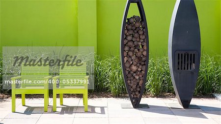 Modern garden with green wall, green funiture and fire place