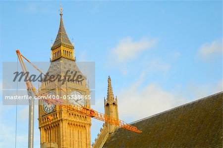 Big Ben in London with a repair crane