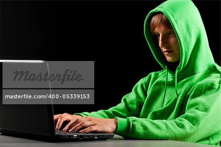 hacker. Young man with laptop is looking at screen