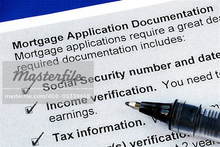 The documents required in a mortgage application isolated on blue