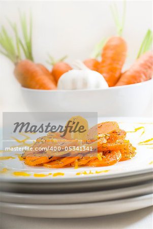 fresh  and healthy Honey glazed carrots on a plate with tyme on top