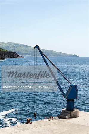 Port crane in a small harbor, Pico, Azores