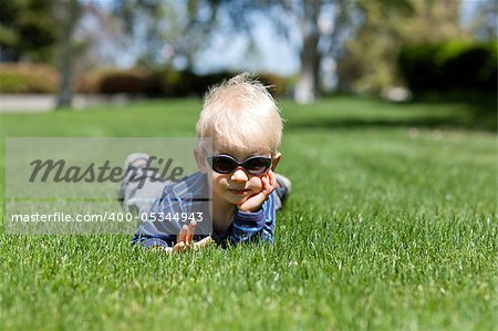adorable toddler lying in the grass