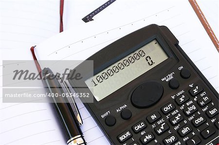 Calculator with one million, pen and notebook.