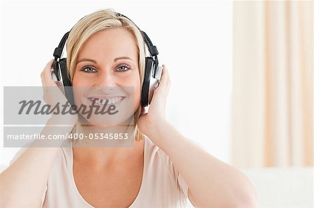 Close up of a lovely woman enjoying some music while looking at the camera