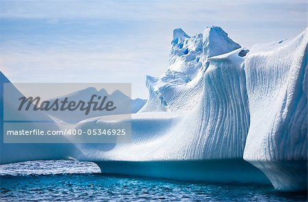 Antarctic iceberg in the snow. Beautiful winter background.