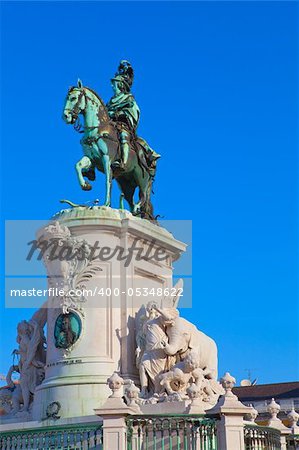 Statue of King Joao I at Figueiroa Square, and St. Jorge castle in Lisbon, Portugal