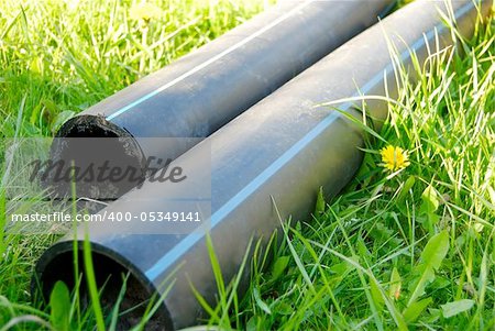 construction pipes lying on the grass during city contruction in spring
