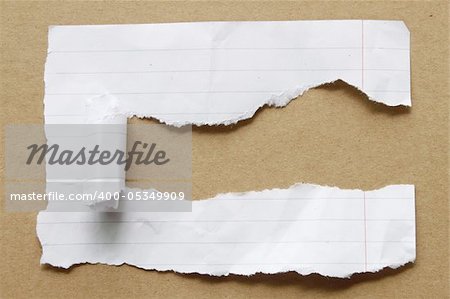 Ripped paper on brown background