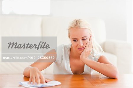 Sad woman with a letter in her living room