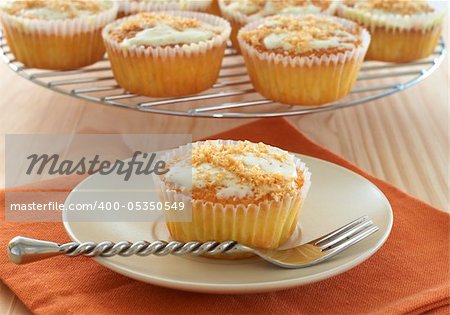 Freshly baked coconut vanilla cupcakes on white plate