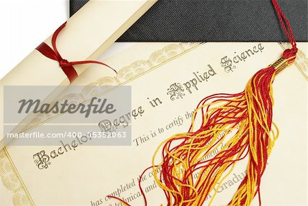 A diploma and grad hat represent a high achieving student in the field of science.