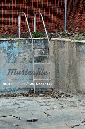 Drained swimming pool in abandoned house.