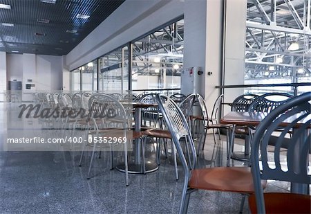 a lot of chairs and tables in fast food cafe