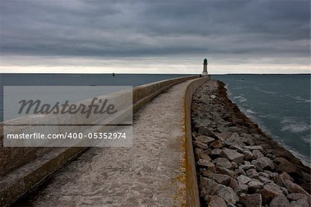 Lighthouse near the ocean. Moody weather before the storm.