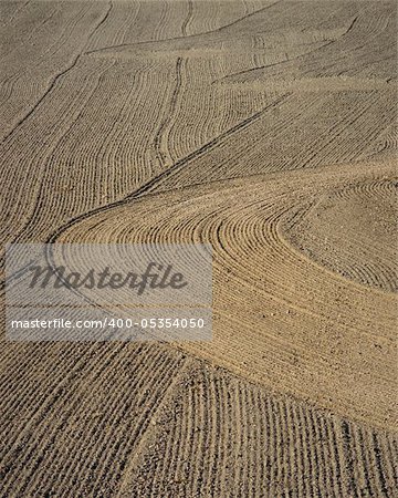 Brown background of plowed field with interesting pattern