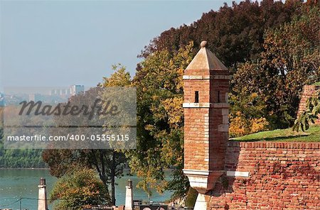 brick tower over autumn trees in park Kalemegdan in Belgrade