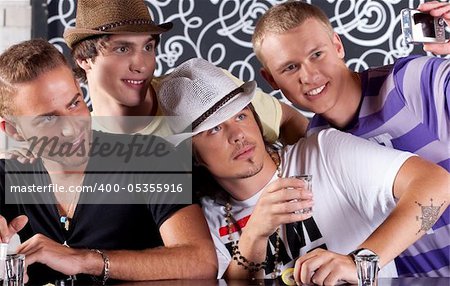 Self portrait of handsome bunch of teens drinking and enjoying in nighclub.