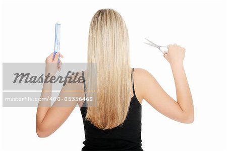 Young blond woman holding hairdresser's tools , isolated on white