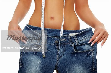 Young woman showing how much weight she lost. Isolated on white