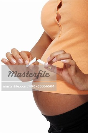 Pregnant woman breaking a cigarette - stop smoking concept