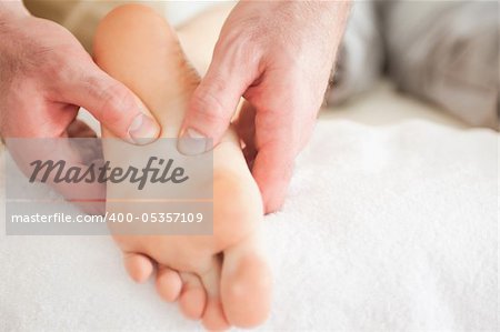 Man massaging a woman's foot in a room
