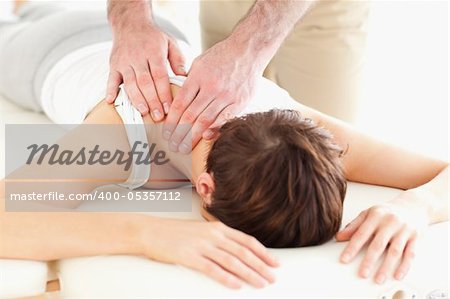 Man massaging a woman's neck in a room