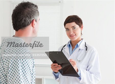 Female Doctor talking to a patient in a room