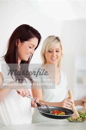 Cheerful Women cooking dinner in a kitchen