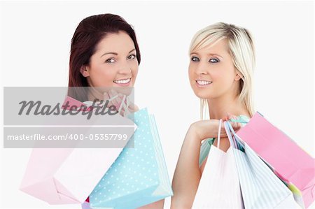 Cute young women with shopping bags in a studio