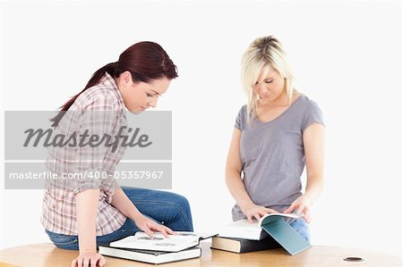 Two lovely female students learning at table