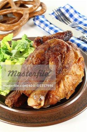 a roast chicken with salad on a plate